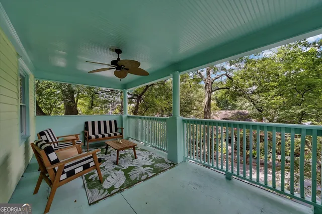 a view of house with street and trees in the background