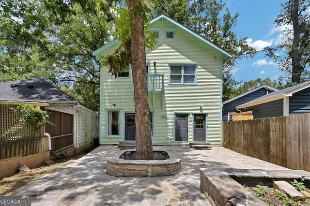 a view of a house with a chairs and table on the wooden floor