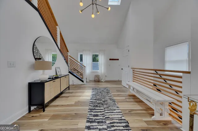 a kitchen with a table chairs and white cabinets