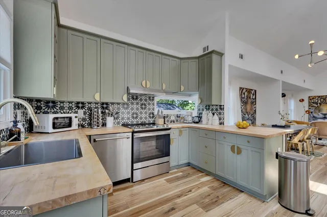 a kitchen with kitchen island granite countertop a sink window and cabinets