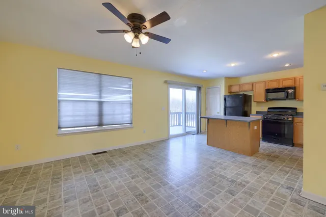 a view of kitchen and kitchen with microwave