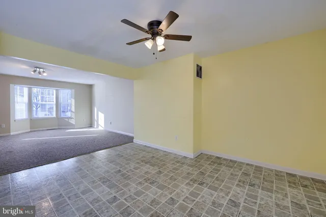 a view of a livingroom with a ceiling fan and window
