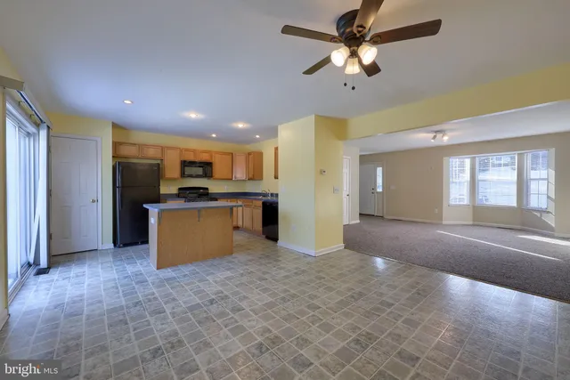 a view of kitchen with a sink and a refrigerator