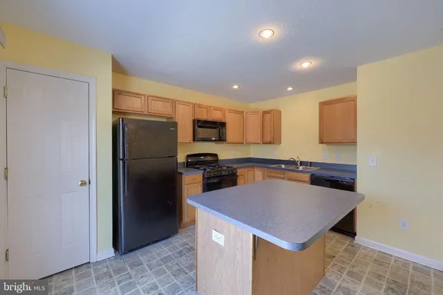 a kitchen with a refrigerator a microwave and a sink