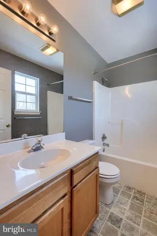 a bathroom with a sink toilet and a mirror