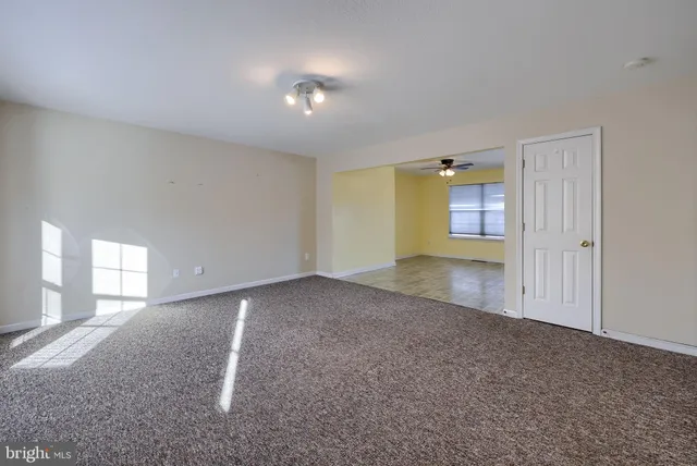 an empty room with a empty space and windows