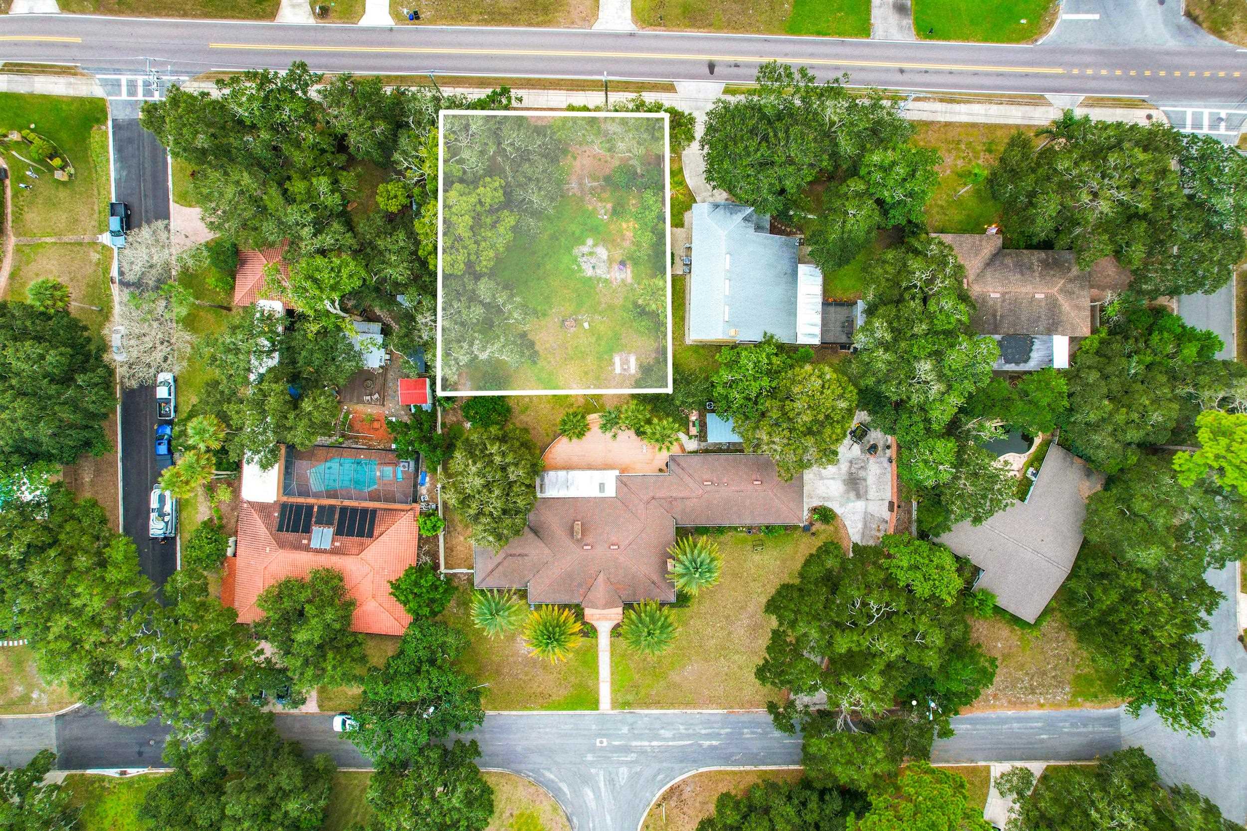 an aerial view of a house with a yard and lake view