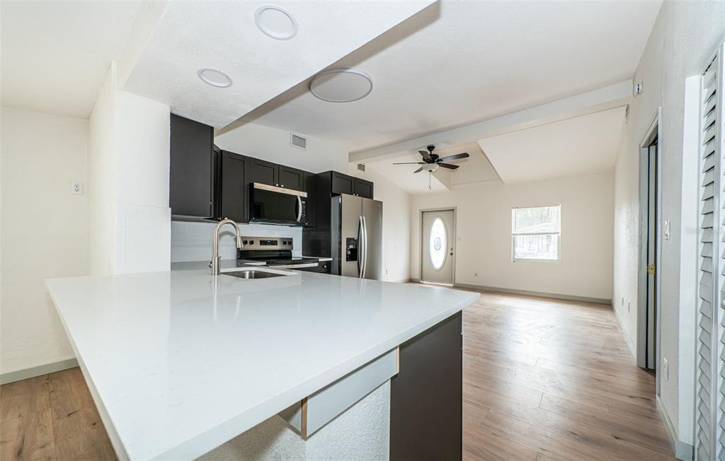 6027 Illinois Avenue New Port Richey, FL 34653 - Photo 17 of 30 a view of a kitchen from a hallway