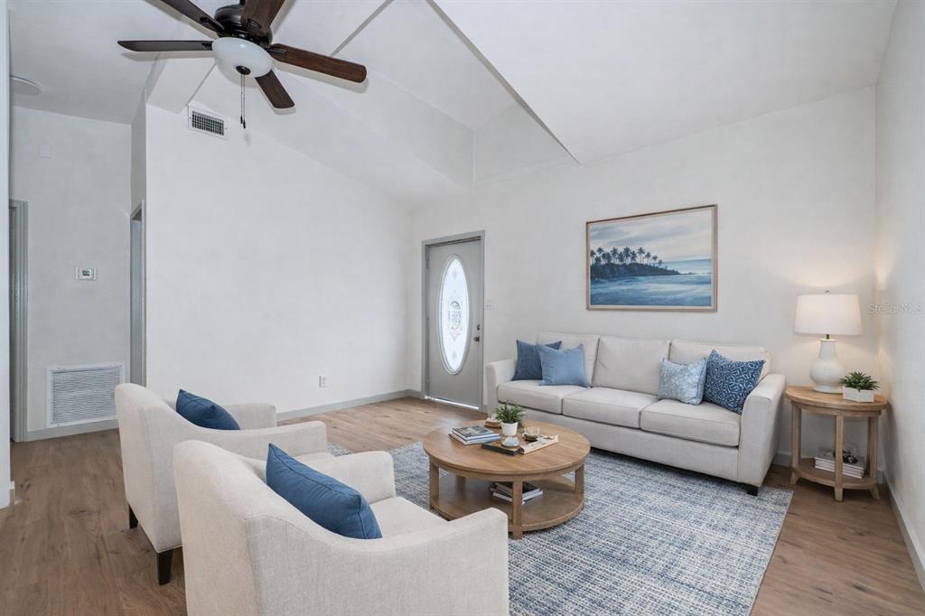 6027 Illinois Avenue New Port Richey, FL 34653 - Photo 2 of 30 a living room with furniture and a rug