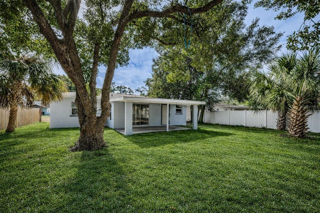 6027 Illinois Avenue New Port Richey, FL 34653 - Photo 29 of 30 a house with a tree in front of a house