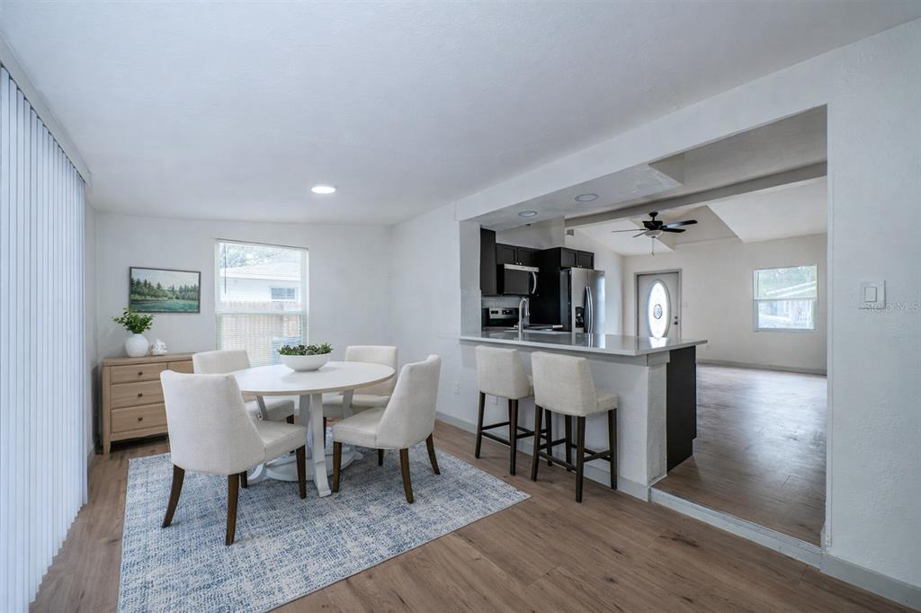6027 Illinois Avenue New Port Richey, FL 34653 - Photo 5 of 30 a view of a dining room with furniture and wooden floor