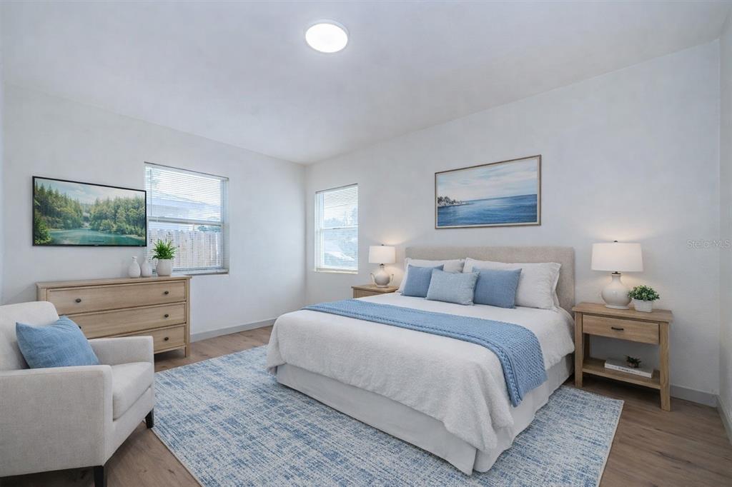 6027 Illinois Avenue New Port Richey, FL 34653 - Photo 8 of 30 a bedroom with a bed and a couch