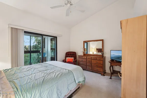 a bedroom with a bed and a mirror