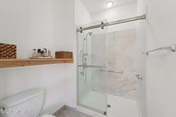 a room with furniture a flat screen tv and a window