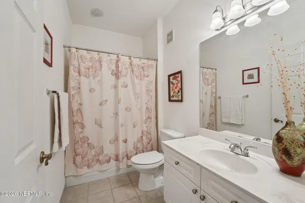 a bedroom with two beds and a large window