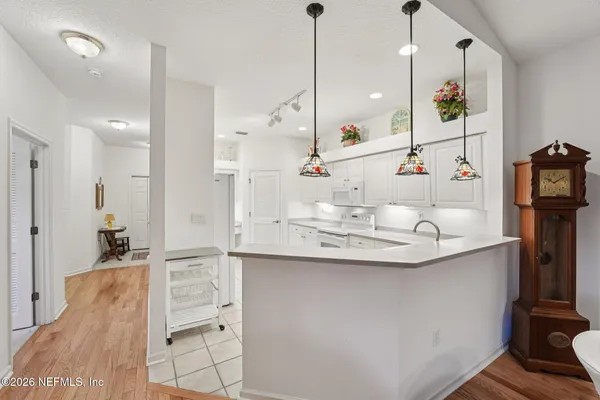 a kitchen with kitchen island a sink appliances and cabinets