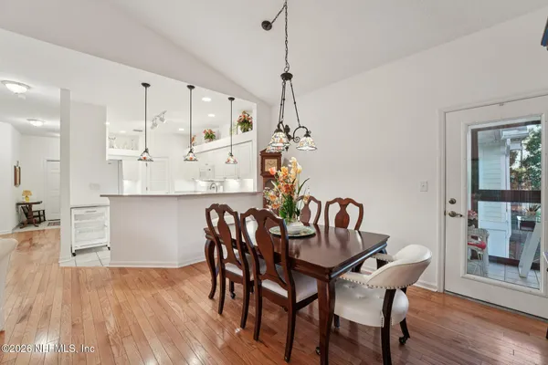 a view of a dining room with furniture and wooden floor