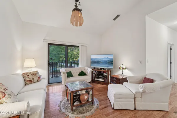 a living room with furniture a couch and a flat screen tv