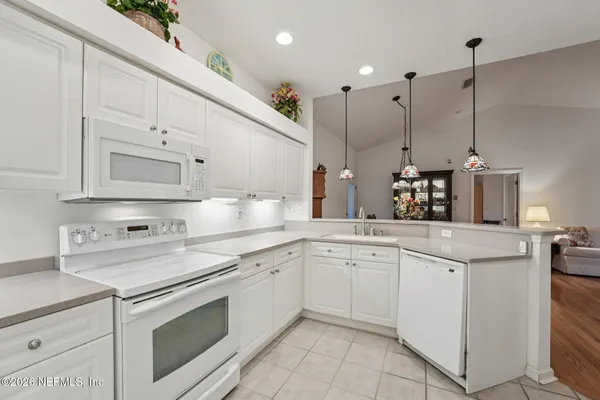 a kitchen with cabinets appliances and a sink