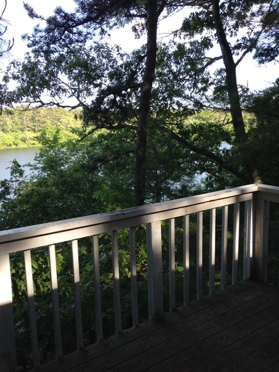117 Barker Road Wareham, MA 02538 - Photo 6 of 6 a balcony with wooden floor and yard in the back