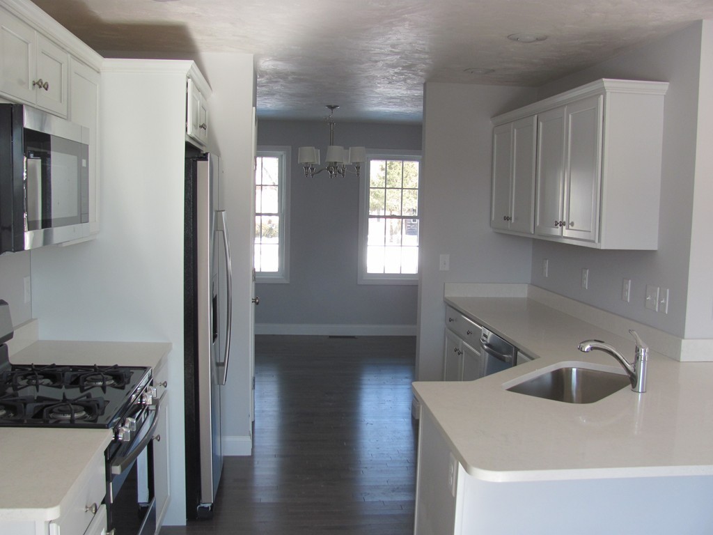 14 Murray Road Ashburnham, MA 01430 - Photo 2 of 15 a kitchen with a sink a refrigerator and cabinets
