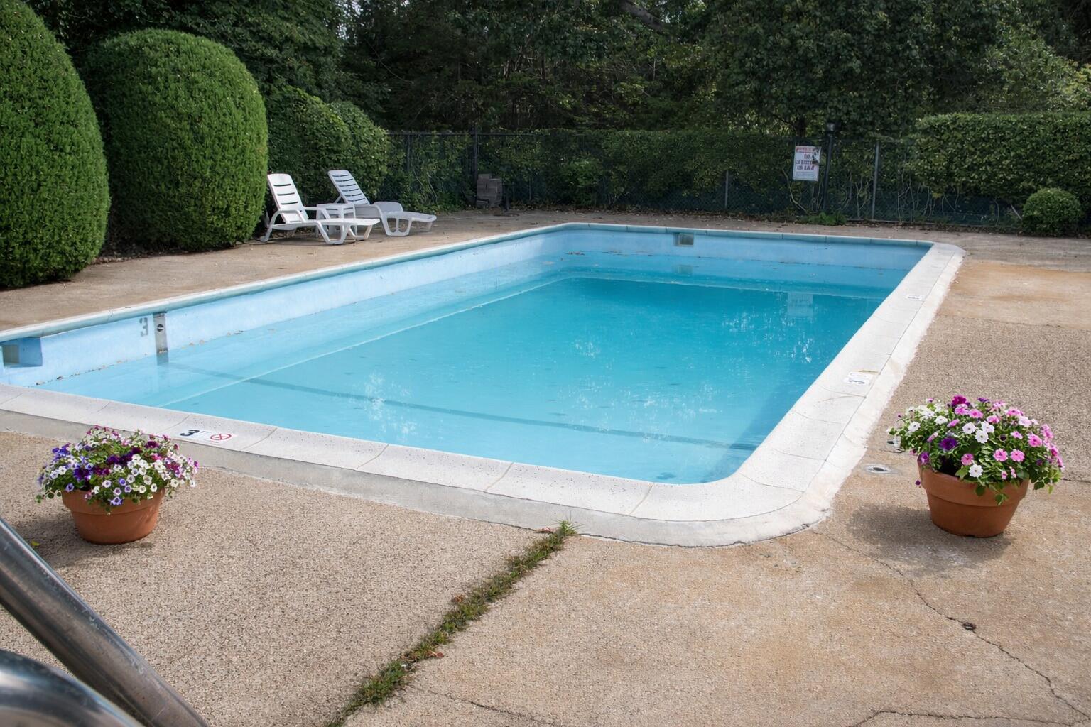 174 Upper County Road, Unit 22 Dennis Port, MA 02639 - Photo 13 of 15 Residential pool with blooming flowers