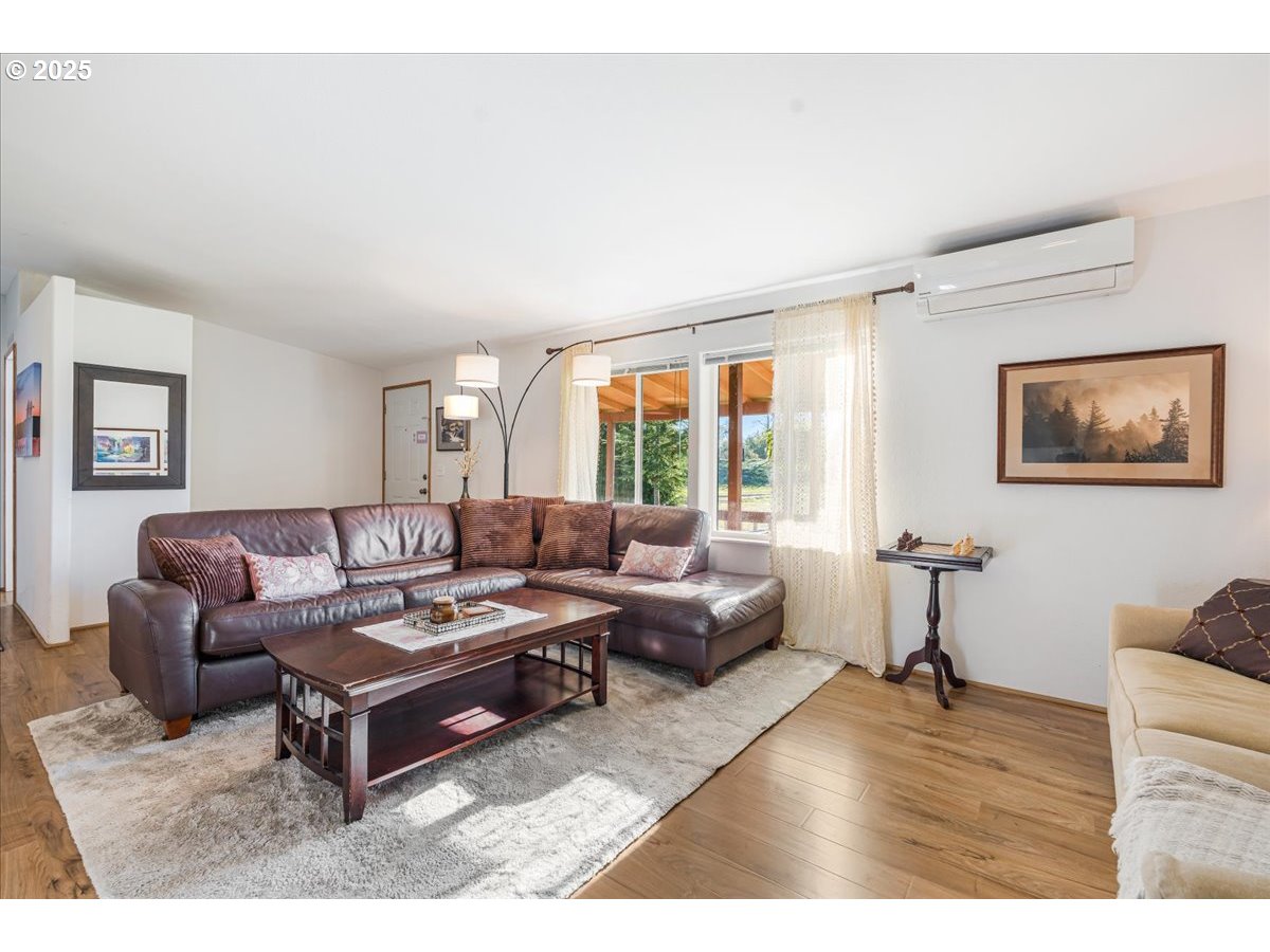 78527 Point Adams Road Clatskanie, OR 97016 - Photo 12 of 46 a living room with furniture a rug and a large window