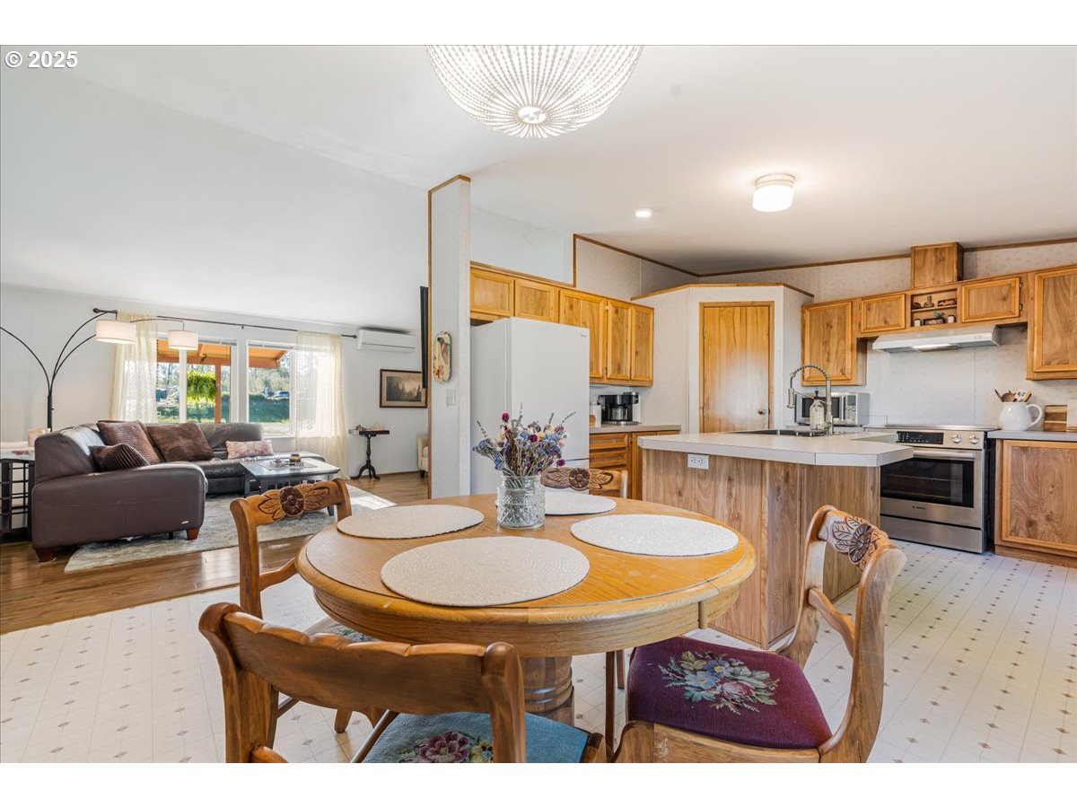 78527 Point Adams Road Clatskanie, OR 97016 - Photo 17 of 46 a open kitchen with stainless steel appliances granite countertop a stove a sink a dining table and chairs