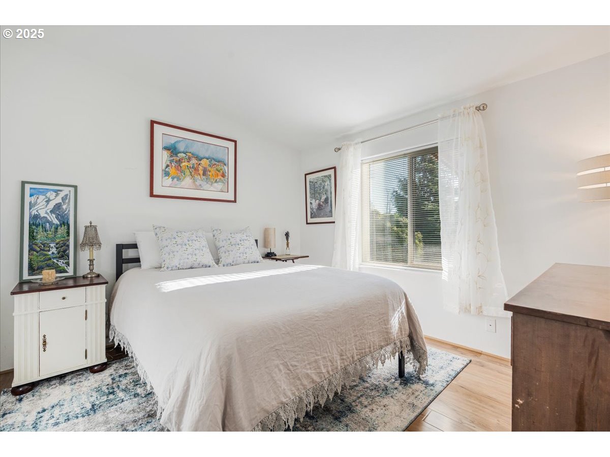 78527 Point Adams Road Clatskanie, OR 97016 - Photo 23 of 46 a bedroom with a bed and a window