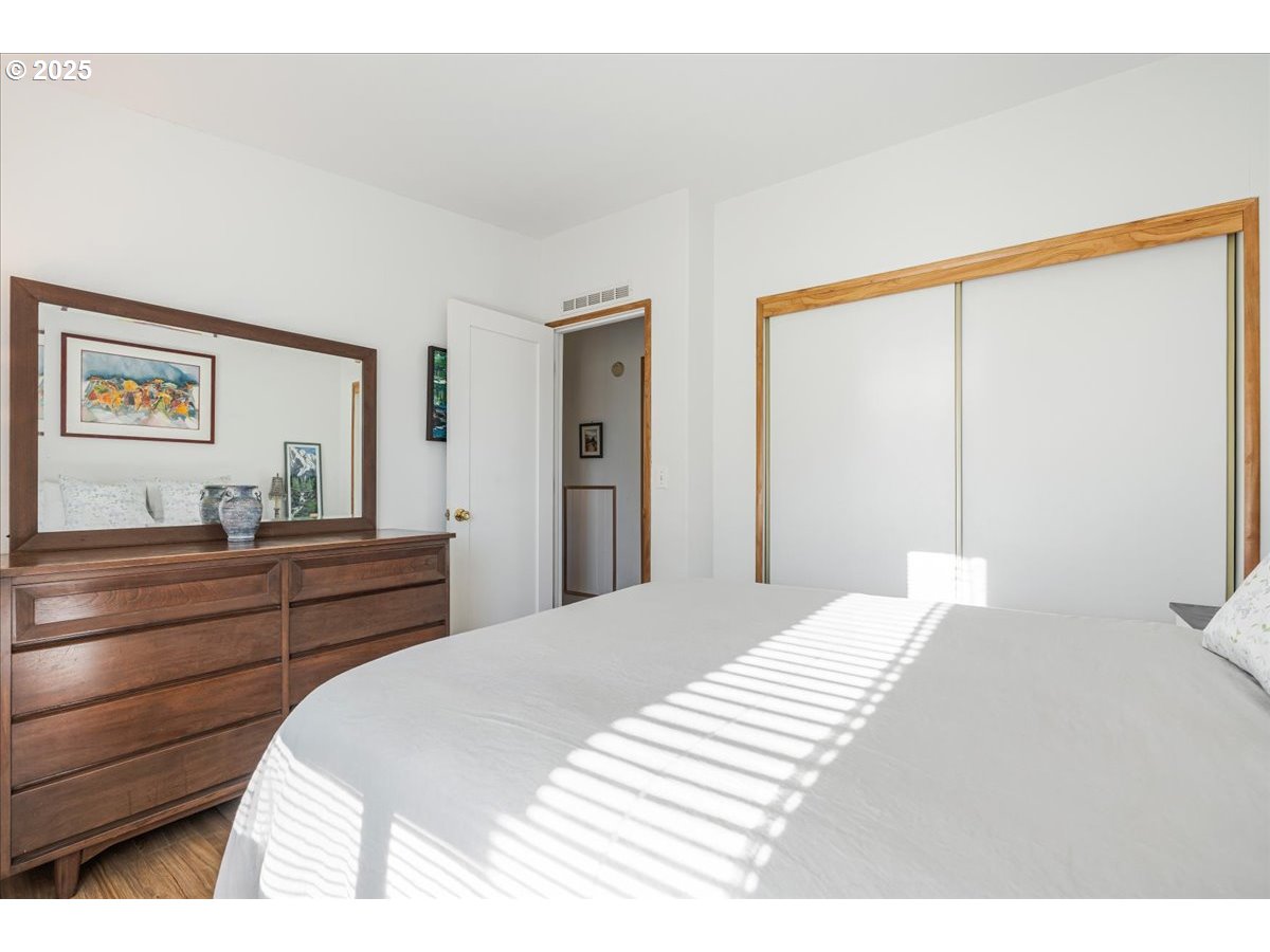 78527 Point Adams Road Clatskanie, OR 97016 - Photo 24 of 46 a bedroom with a bed and a large mirror