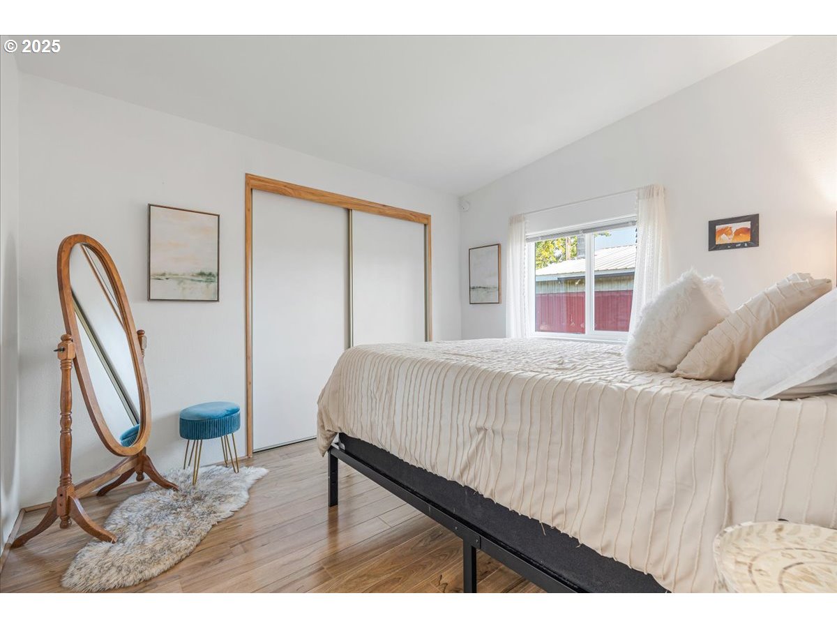 78527 Point Adams Road Clatskanie, OR 97016 - Photo 25 of 46 a bedroom with a bed and a large mirror