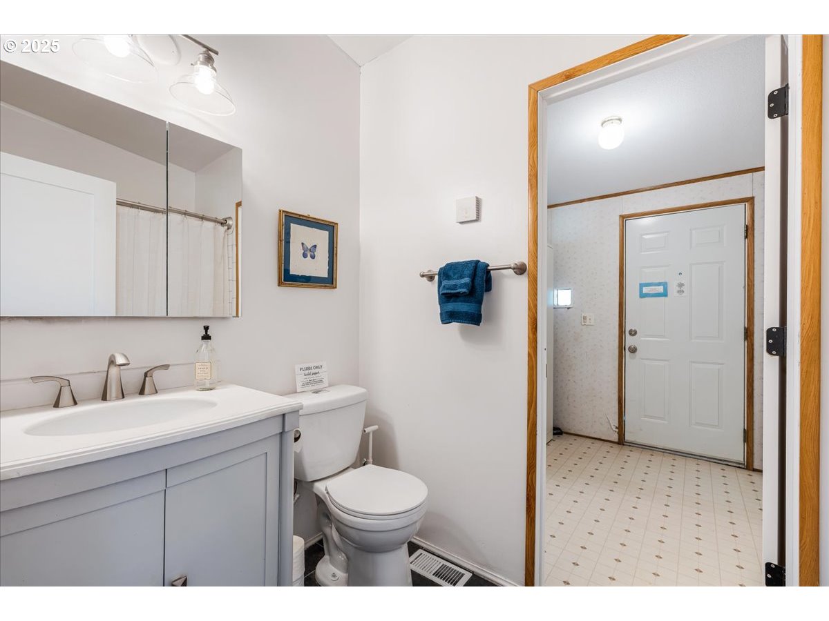 78527 Point Adams Road Clatskanie, OR 97016 - Photo 26 of 46 a bathroom with a toilet sink and mirror