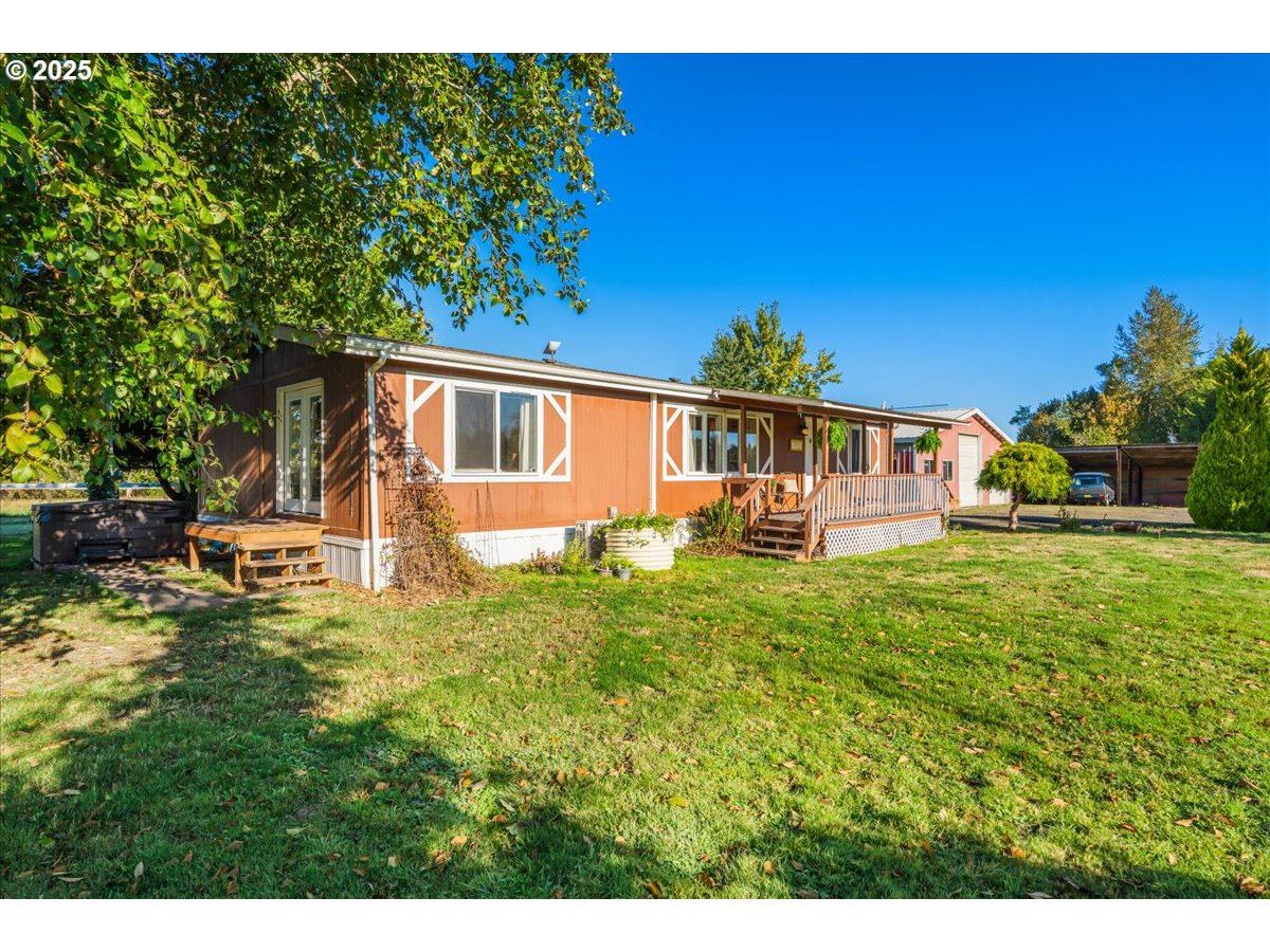 78527 Point Adams Road Clatskanie, OR 97016 - Photo 10 of 46 a backyard of a house with table and chairs