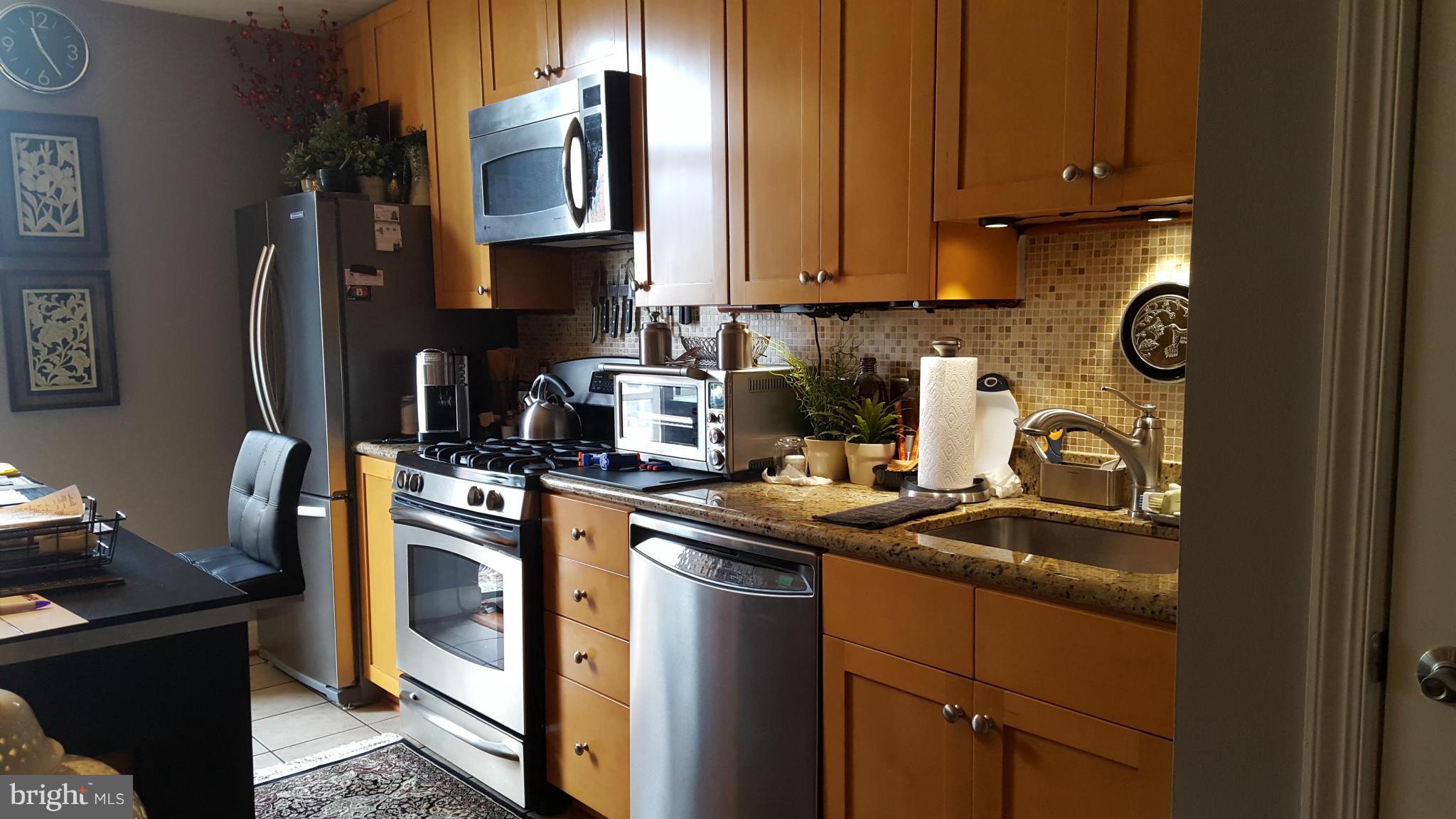 3650 South Glebe Road, Unit 649 Arlington, VA 22202 - Photo 4 of 22 a kitchen with stainless steel appliances granite countertop a sink stove and refrigerator