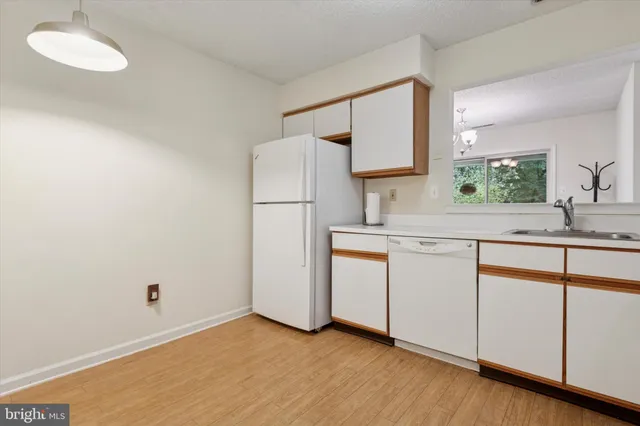 a kitchen with sink cabinets and a window
