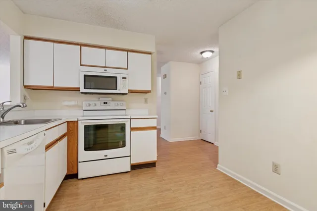 a kitchen with a stove microwave and sink