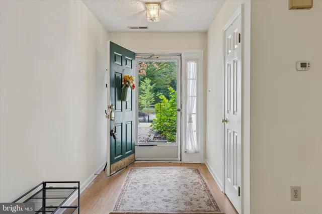 a view of a hallway to rooms