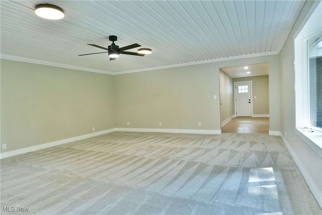 7655 Connelly Road Masury, OH 44438 - Photo 34 of 46 Unfurnished room featuring light colored carpet, ornamental molding, ceiling fan, and wood ceiling