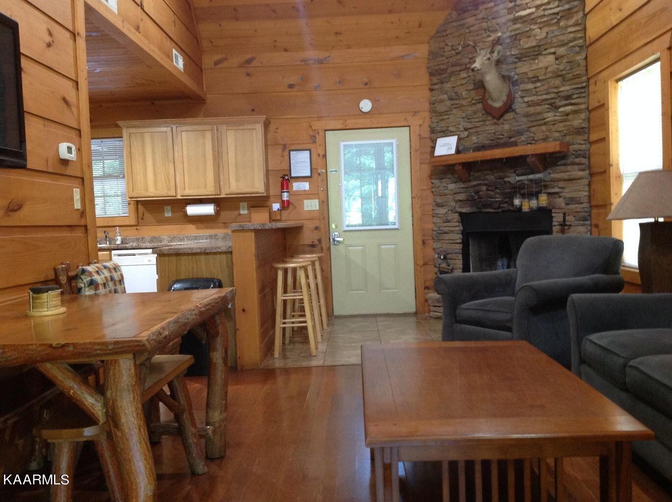315 Windrock Road Oliver Springs, TN 37840 - Photo 11 of 36 a living room with furniture a fireplace and a table