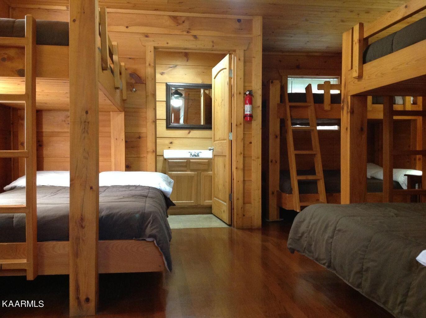 315 Windrock Road Oliver Springs, TN 37840 - Photo 19 of 36 a bedroom with a bed and wooden floor