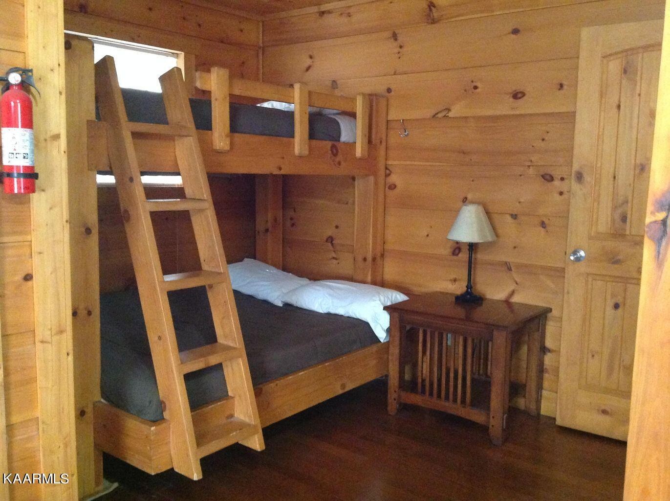 315 Windrock Road Oliver Springs, TN 37840 - Photo 21 of 36 a bedroom with a bed and wooden floor