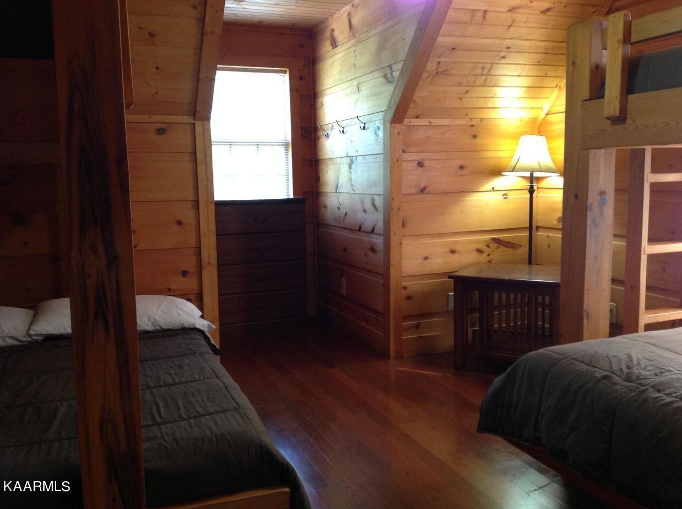 315 Windrock Road Oliver Springs, TN 37840 - Photo 23 of 36 a bedroom with a bed and wooden floor