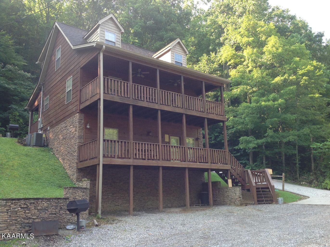 315 Windrock Road Oliver Springs, TN 37840 - Photo 3 of 36 a front view of a house with a yard and garage