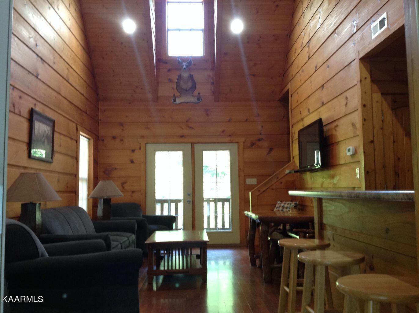 315 Windrock Road Oliver Springs, TN 37840 - Photo 7 of 36 a living room with furniture a fireplace and a flat screen tv