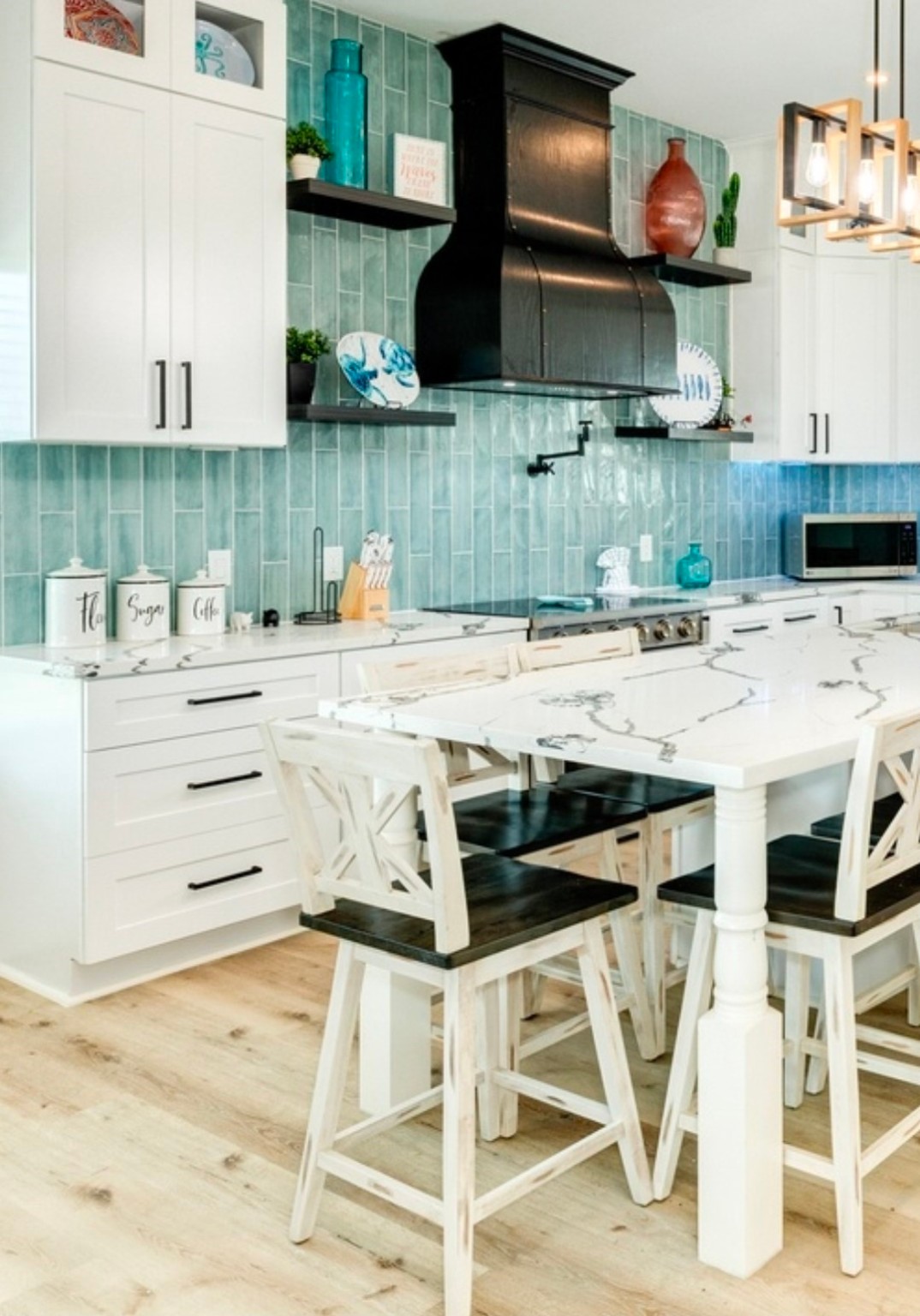 23245 Termini-San Luis Pass Road Galveston, TX 77554 - Photo 11 of 45 a kitchen with stainless steel appliances kitchen island granite countertop a stove and white cabinets