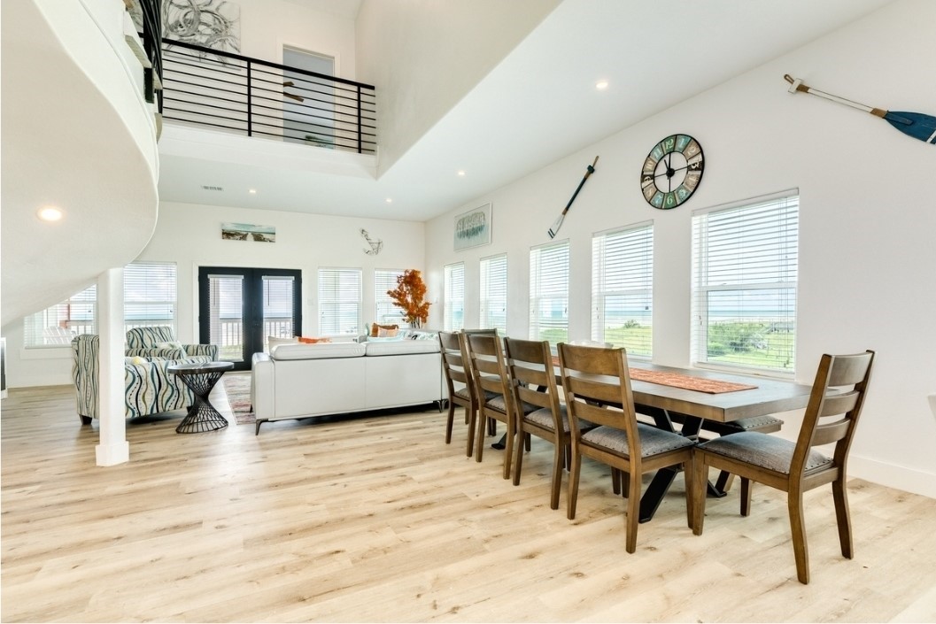 23245 Termini-San Luis Pass Road Galveston, TX 77554 - Photo 14 of 45 a view of a dining room and livingroom with furniture wooden floor and a rug