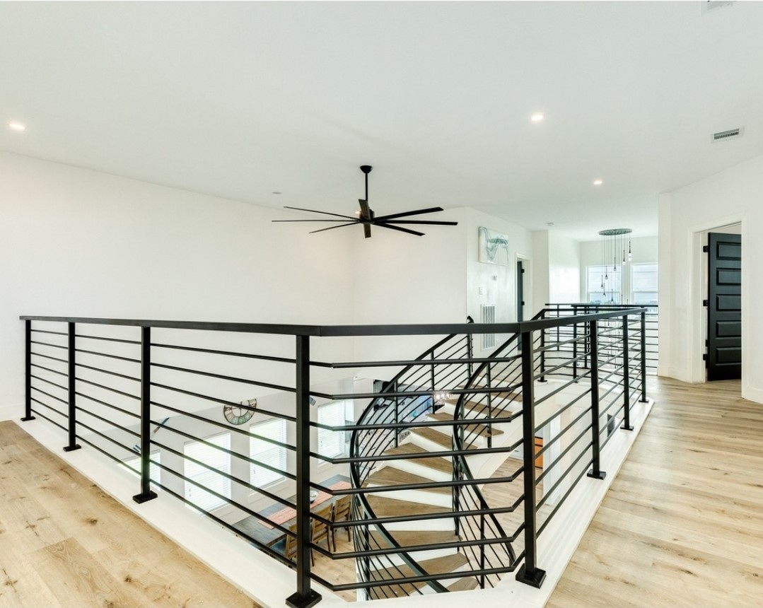 23245 Termini-San Luis Pass Road Galveston, TX 77554 - Photo 20 of 45 a view of a hallway with wooden floor and staircase