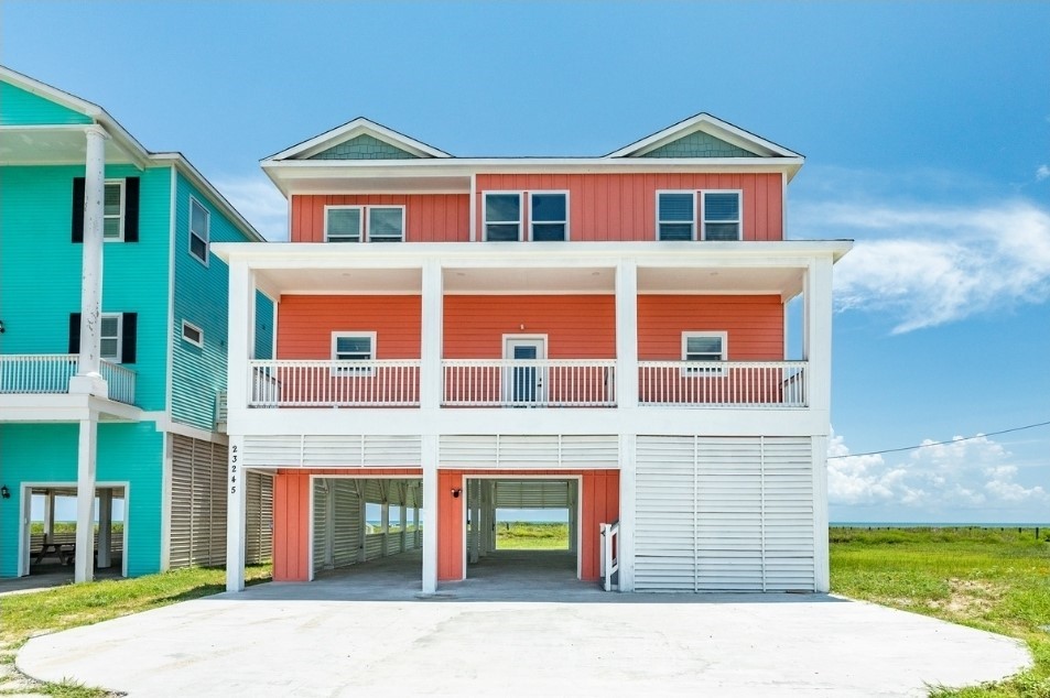 23245 Termini-San Luis Pass Road Galveston, TX 77554 - Photo 2 of 45 a front view of a house with a yard and garage