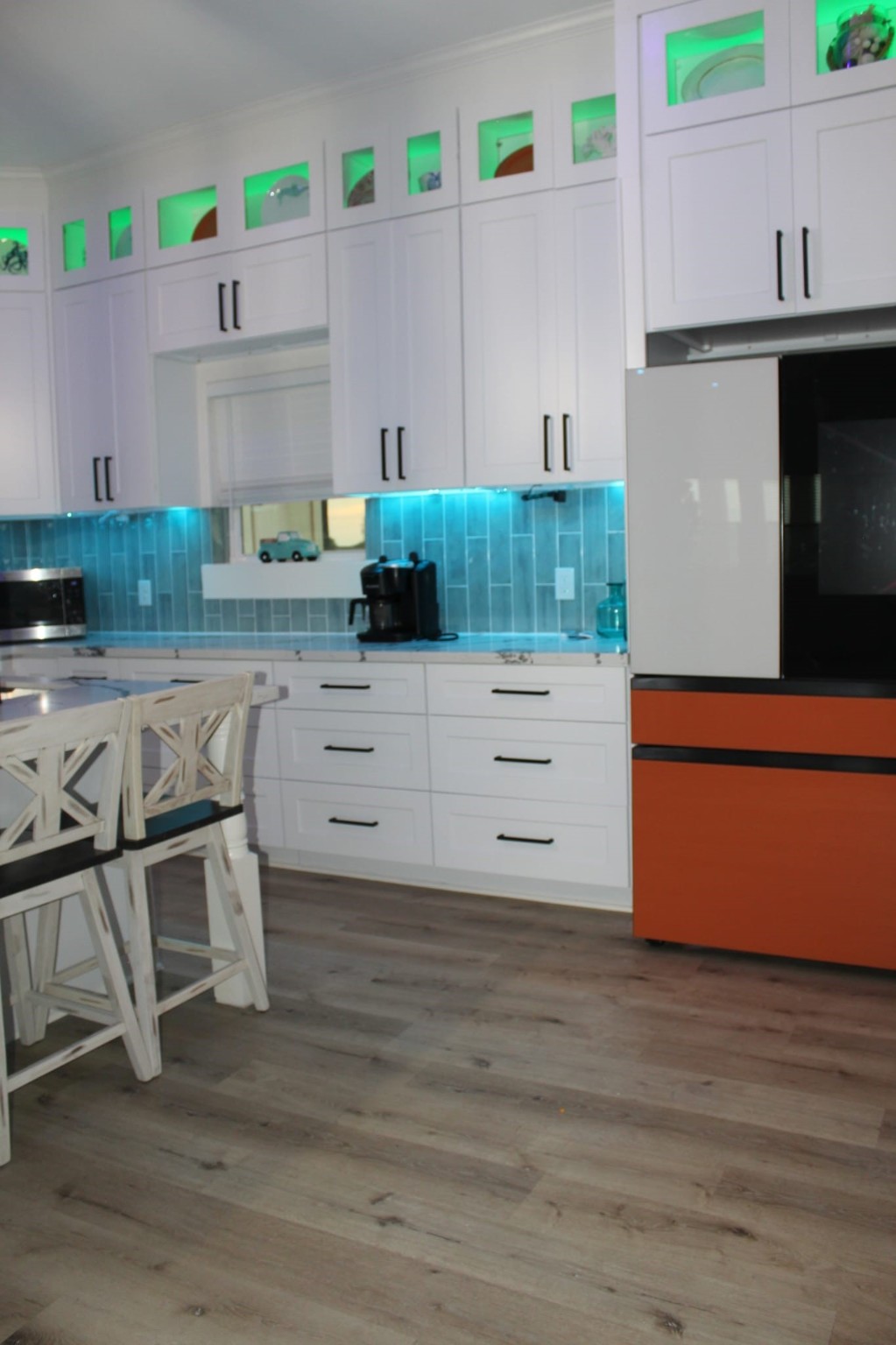 23245 Termini-San Luis Pass Road Galveston, TX 77554 - Photo 26 of 45 a kitchen with stainless steel appliances white cabinets and wooden floor