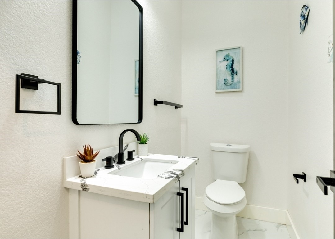 23245 Termini-San Luis Pass Road Galveston, TX 77554 - Photo 32 of 45 a bathroom with a toilet sink and mirror
